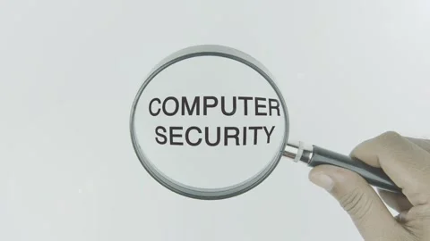 Computer Security text or word highlighted by a magnifying glass in a hand Stock Footage 303604388