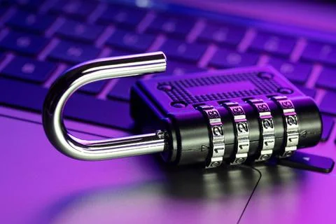 Computer Security Vulnerability concept. Open padlock on laptop with color... Stock Photos