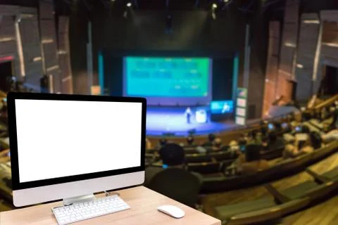 Computer set showing the white screen over the Abstract blurred photo of conf Stock Photos