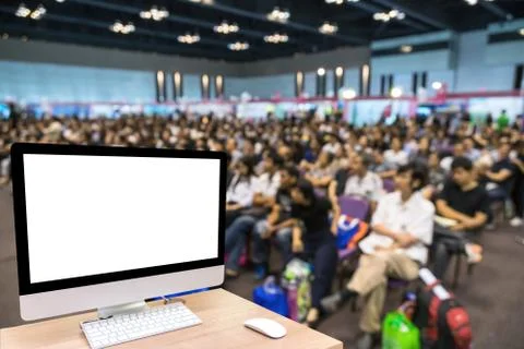 Computer set showing the white screen over the Abstract blurred photo of conf Foto stock