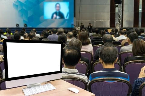 Computer set showing the white screen over the Abstract blurred photo of conf Foto stock