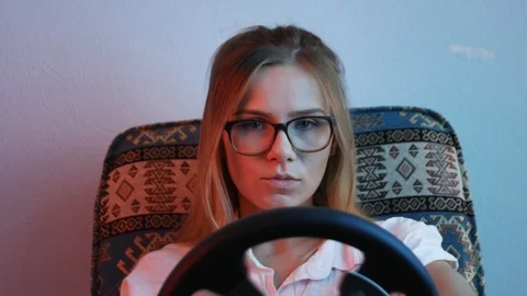 Computer simulation. Concentreted young gamer is expressing excitement while  Vidéo 113546853