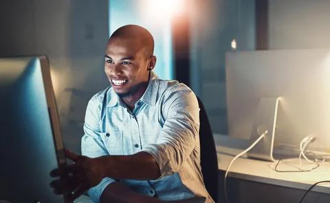 Computer, smile and web design with developer black man in office at night for Foto stock