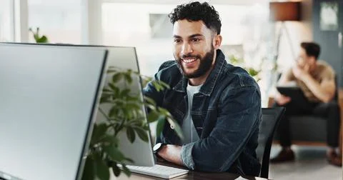 Computer, smile and web development with man in creative workplace for coding or Foto stock
