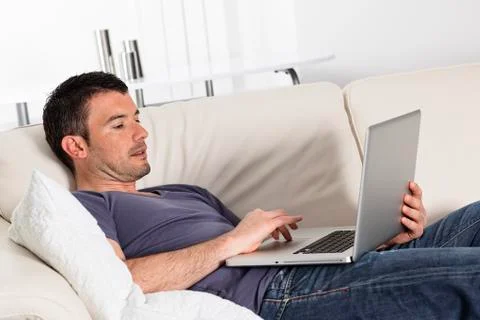 Computer on sofa Stock Photos