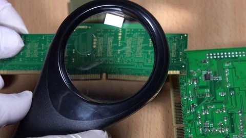 Computer specialist examine RAM memory module with magnifying glass Stock Footage 73800749