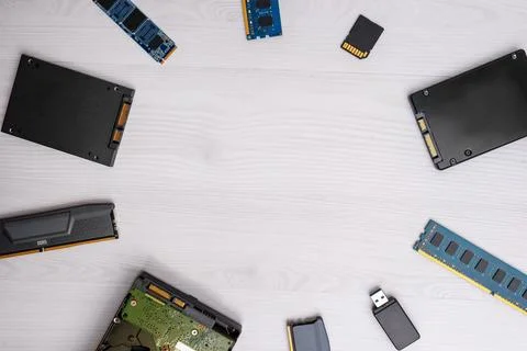 Computer storage components arranged around empty copy space on light woode.. Stock Photos