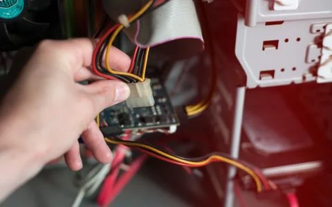 Computer support engineer troubleshooting an office computer. Inside details  Stock Photos