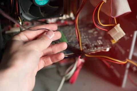 Computer support engineer troubleshooting an office computer. Inside details  Stock Photos