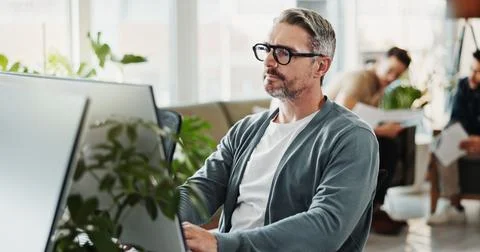 Computer, system and web developer with man programmer in office for coding or Stock Photos