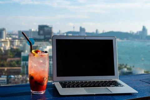 The computer is on the table near the panoramic window with a beautiful Stock Photos