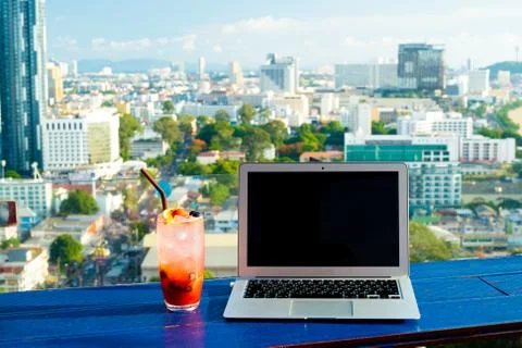 The computer is on the table near the panoramic window with a beautiful Stock Photos