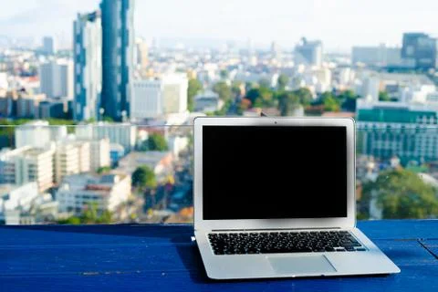 The computer is on the table near the panoramic window with a beautiful Stock Photos