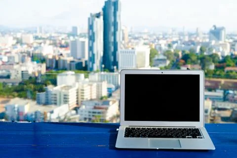 The computer is on the table near the panoramic window with a beautiful Stock Photos