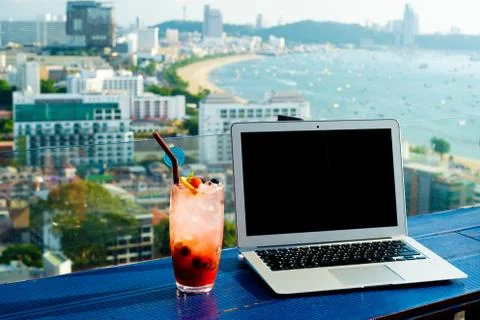 The computer is on the table near the panoramic window with a beautiful Stock Photos
