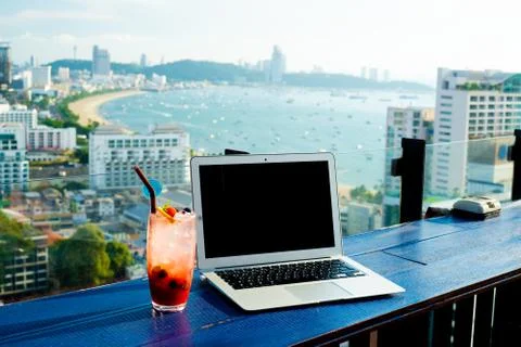The computer is on the table near the panoramic window with a beautiful 스톡 사진
