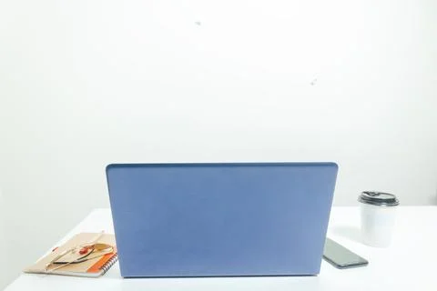 Computer on the table with notebook and glass of coffee and mobile Stock Photos