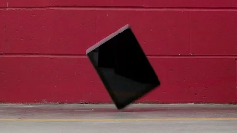Computer tablet falling on concrete and breaking Video stock 75402444