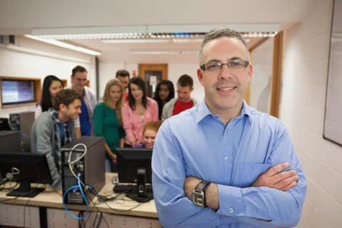 Computer teacher standing in front of his class Stock Photos