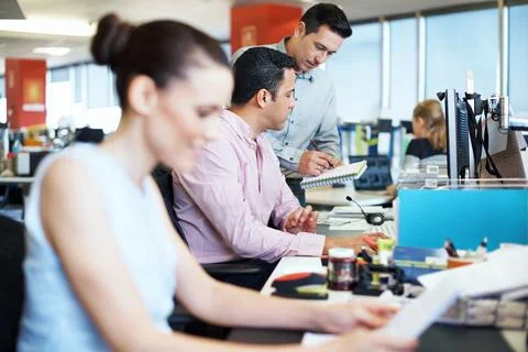 Computer, team and advice on notebook in office for blog ideas, article tips and Stock Photos