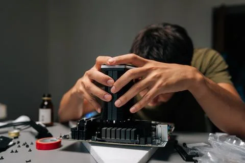 Computer technician carefully installing CPU cooler onto motherboard, performing Stock Photos