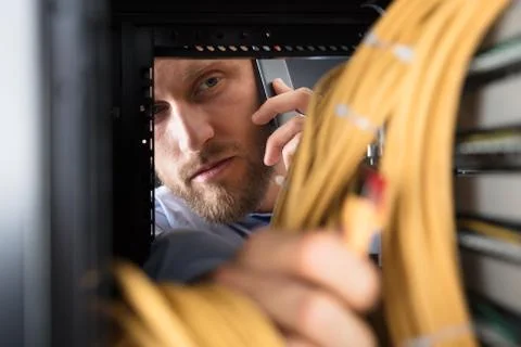 Computer Technician Checking The Server Stock-Fotos