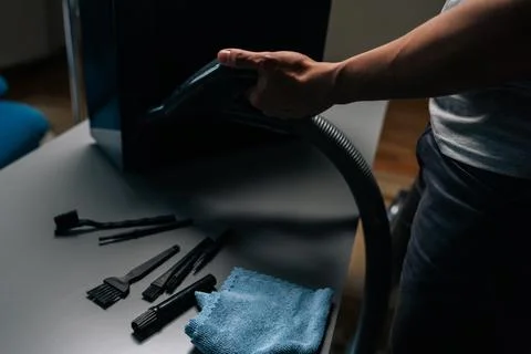 Computer technician cleaning computer case with vacuum cleaner, different Stock Photos