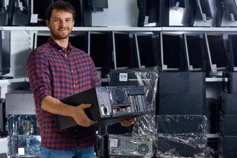 Computer technician engineer holding a broken personal computer. Stock Photos