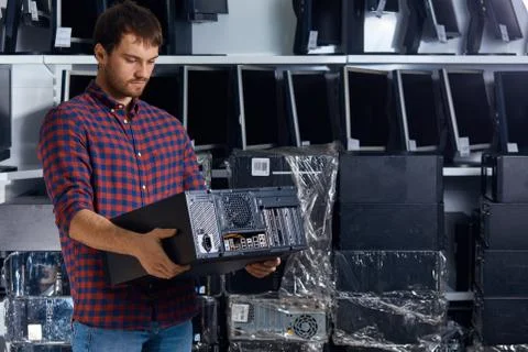 Computer technician engineer holding a broken personal computer. Stock Photos
