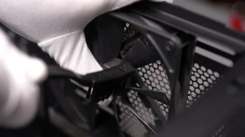 Computer technician in gloves cleaning dusty fan in desktop case, ensuring Stock Footage 287514799