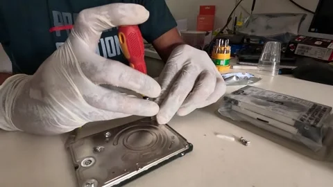 Computer technician is having a heart drive repaired Stock Footage 247818141
