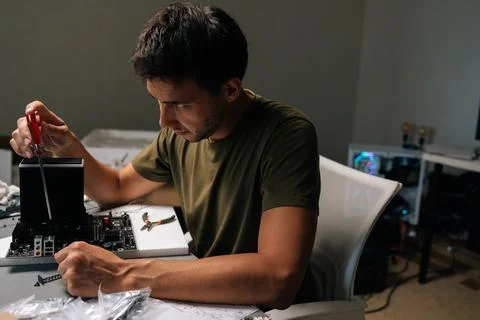 Computer technician installing CPU cooler on motherboard, handling delicate Stock Photos