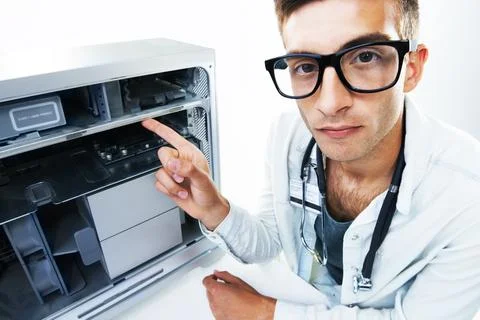 Computer technician, man and pointing at tech hardware, electronics or machine Stock Photos