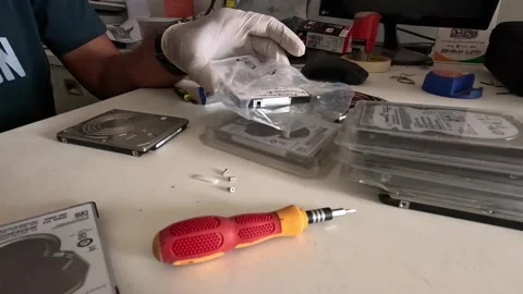 Computer technician is repairing a hard disk in a dark room Stock Footage 247818229
