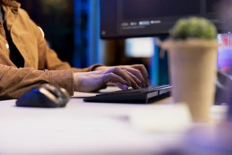 Computer technician typing lines of code on keyboard, close up shot 写真素材