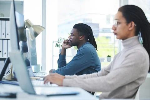 Computer, thinking and employees working in a company or startup agency typing Stock Photos
