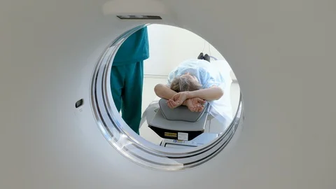 Computer tomograph scanning body or brain of elderly woman in medical clinic. 4K Video stock 122663970