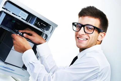 Computer tower, portrait and happy man repair studio hardware, electronics or Stock Photos