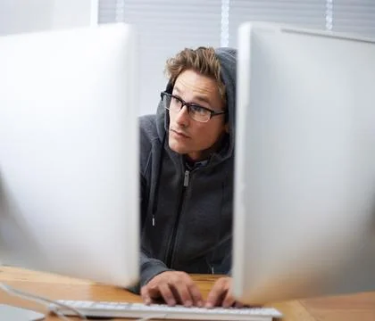Computer, typing and man hacking online database, system or software via Stock Photos