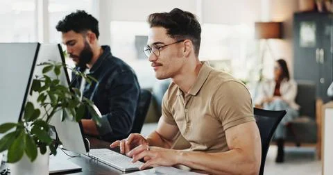 Computer, typing and web development with man programmer in creative workplace Foto stock