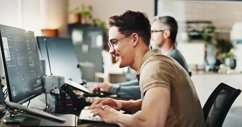 Computer, typing and web development with happy man in creative workplace for Stock-Fotos