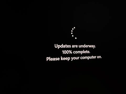 Computer update screen with progress message and loading symbol 스톡 사진