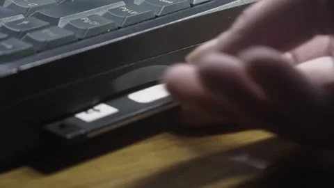 Computer user ejects floppy disc data storage from laptop CLOSE-UP Stock Footage 311572677
