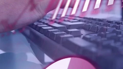 Computer user hand typing on keyboard, activating red overlays and updating tech Stock Footage 333962581