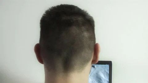 Computer user, pensively scratches his head. Video stock 71679425