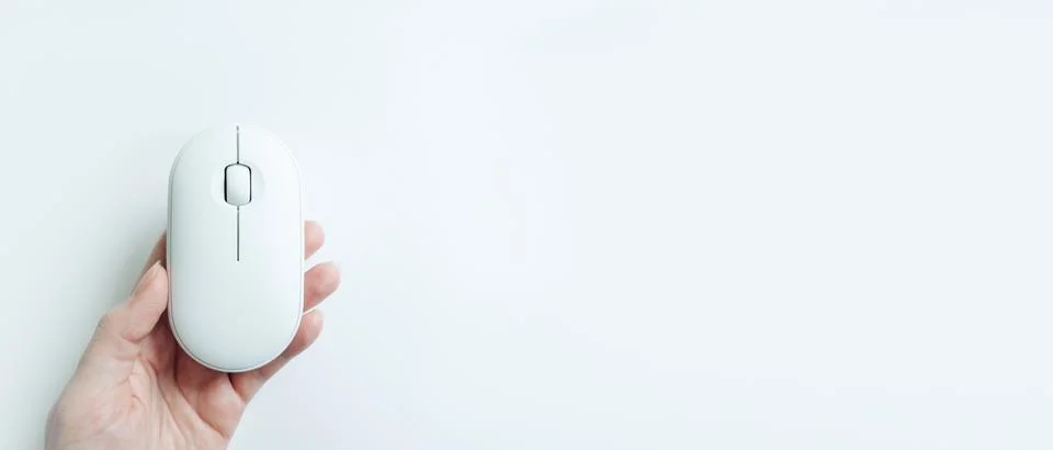 Computer white mouse in hand on a white background in banner format. Computer Stock Photos
