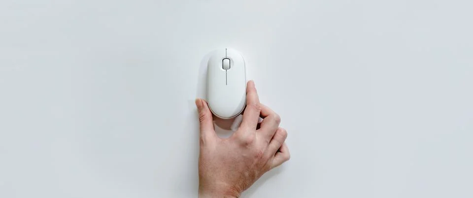 Computer white mouse in hand on a white background in banner format. Computer Stock Photos