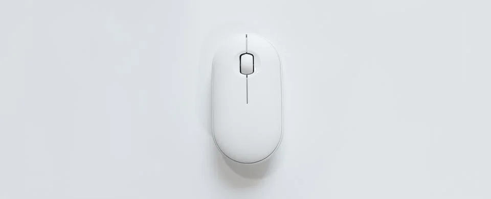 Computer white mouse in hand on a white background in banner format. Computer Stock Photos