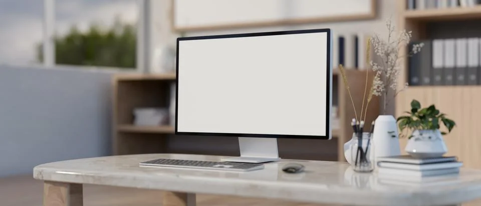 A computer white-screen mockup on a luxury marble table in a modern office .. Stock-Illustration