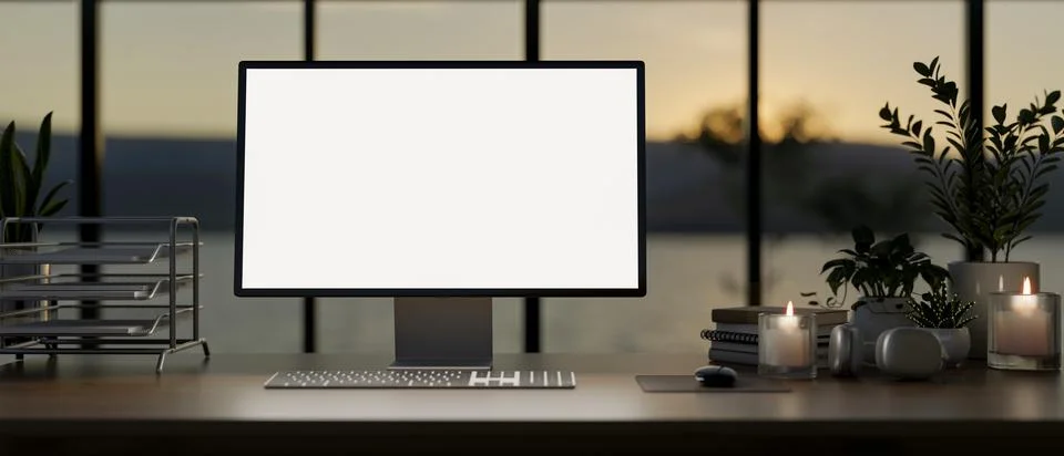 A computer with a white-screen mockup on a table against the window in a mo.. Illustrazione stock